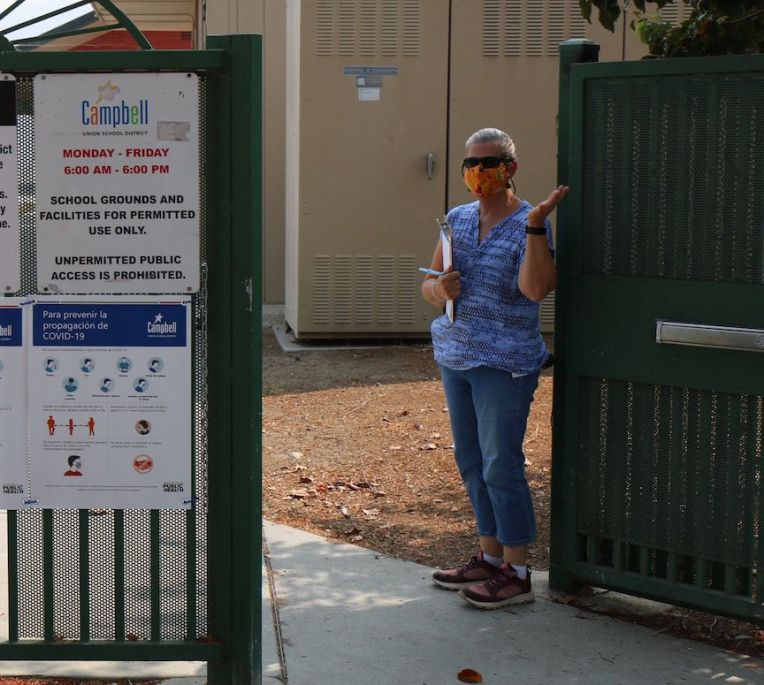 staff in mask at gate