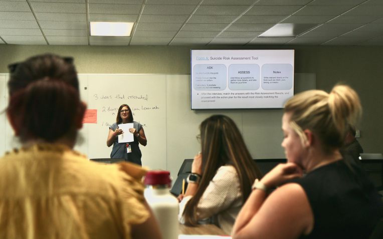 woman speaks to workshop attendees