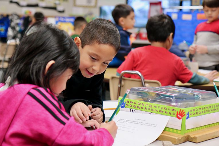 two students collaborating and smiling