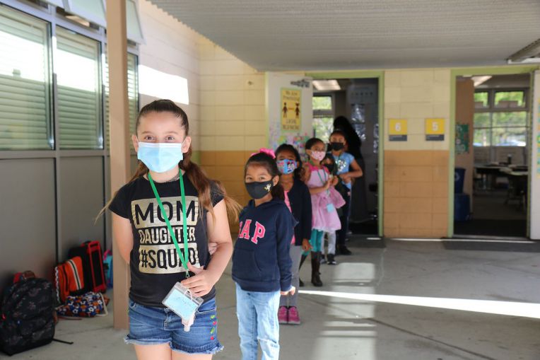 students lined up outside classroom