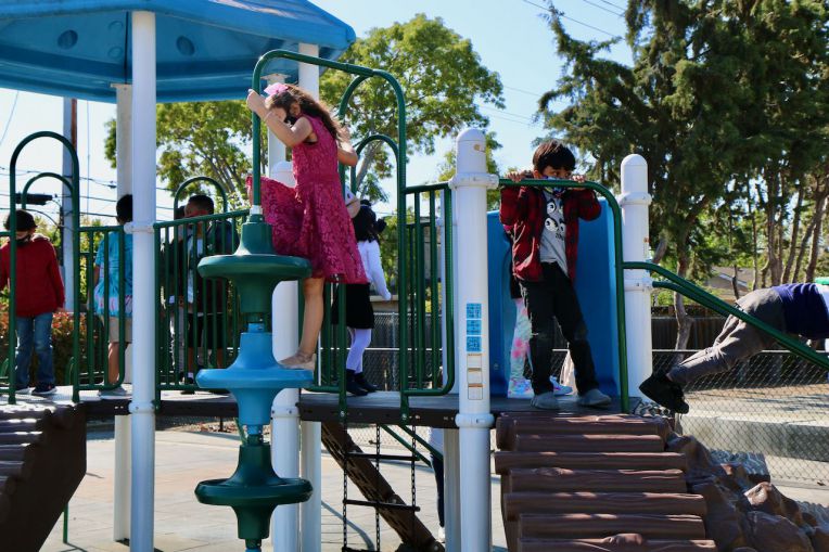 students on play structure