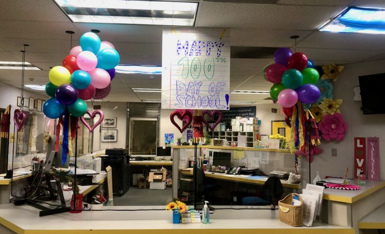 office with balloons and signs