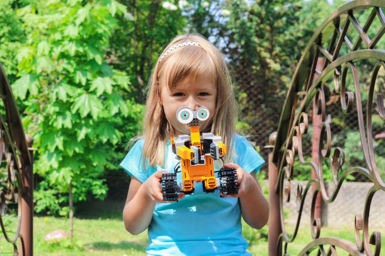 girl holding lego robot