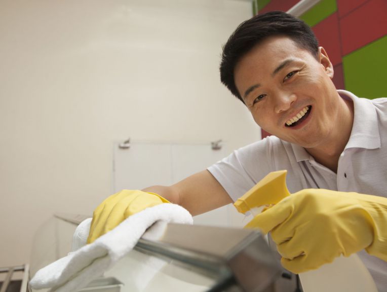 man cleaning counter