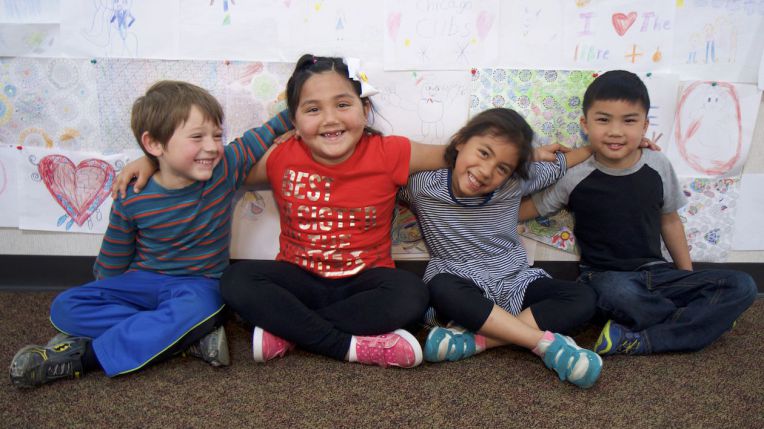 four students smiling