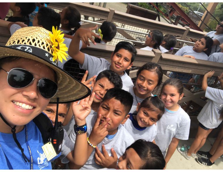 smiling woman with students