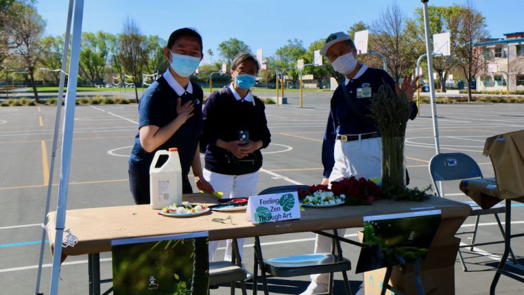 three adults at a zen art table